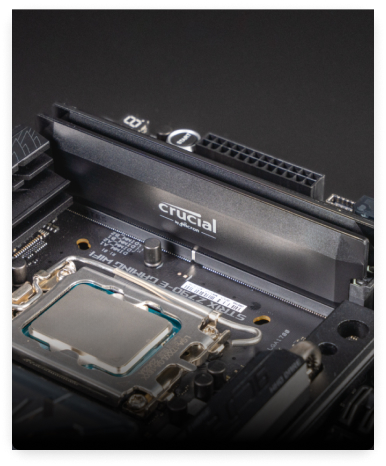 A macro shot of a motherboard with a Crucial DRAM installed.