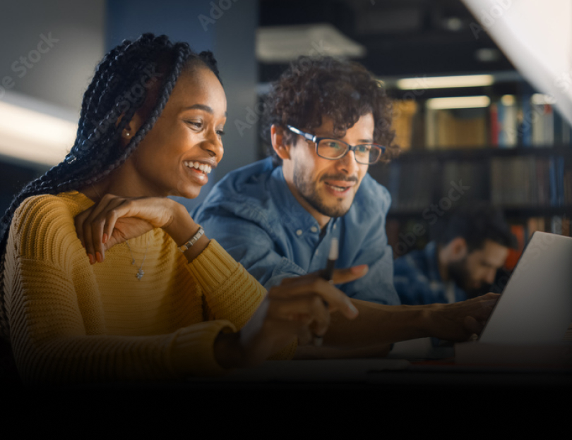 Two girls in a classroom setting working on a robotics assignment on a laptop.