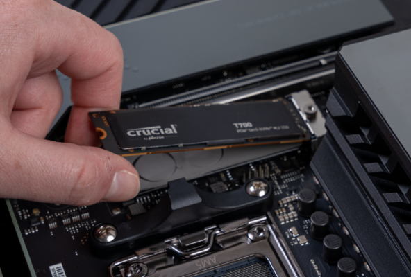 A Crucial T700 being slotted into a motherboard.